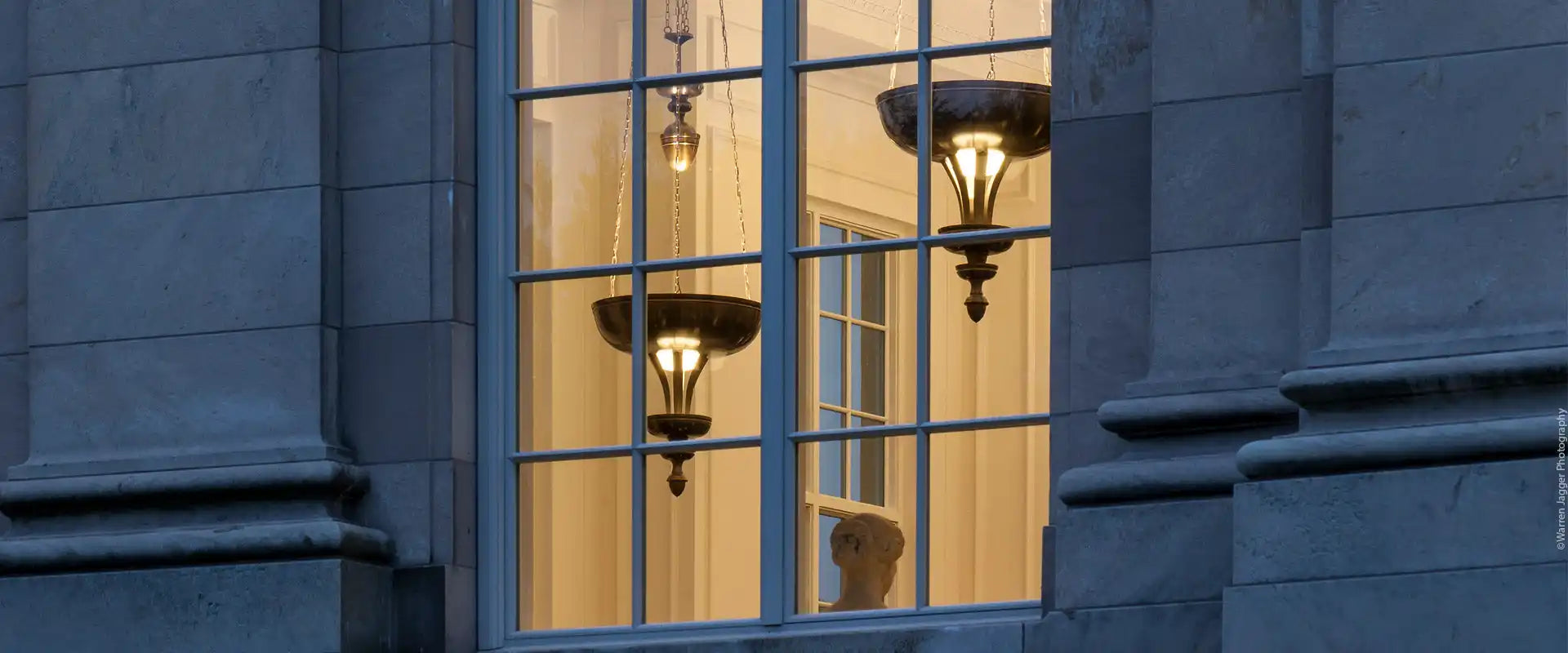A window with ornate hanging light fixtures.