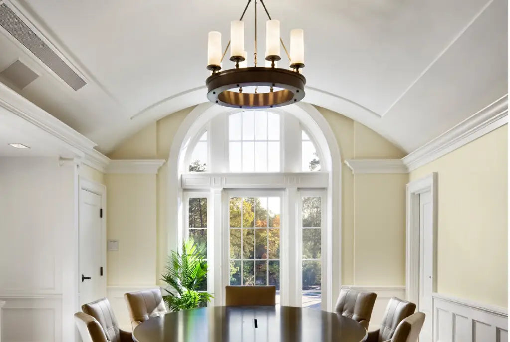 Conference room with a large table and chairs, chandelier, and large window.