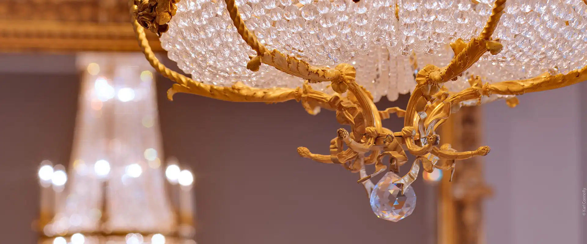 An elaborate gold and crystal chandelier.