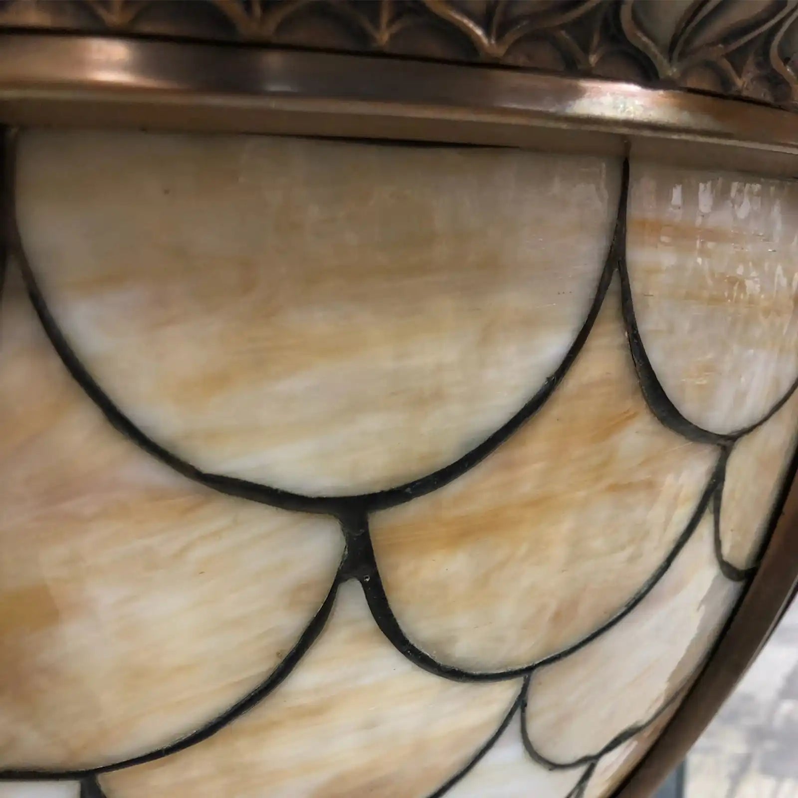 Stained glass lamp shade with scallop pattern.
