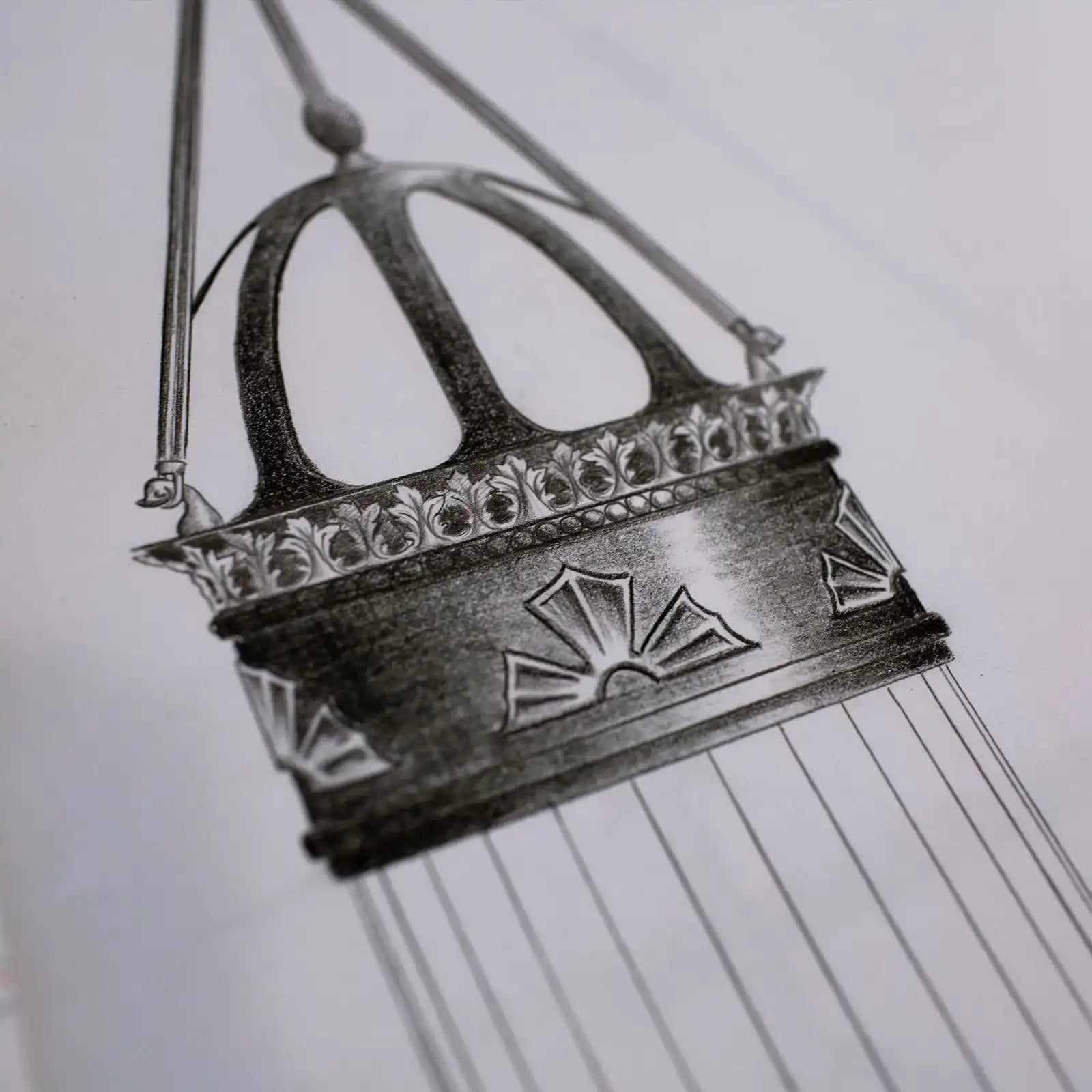 An ornate, hanging metal incense burner with a detailed crown-like top and decorative patterns.