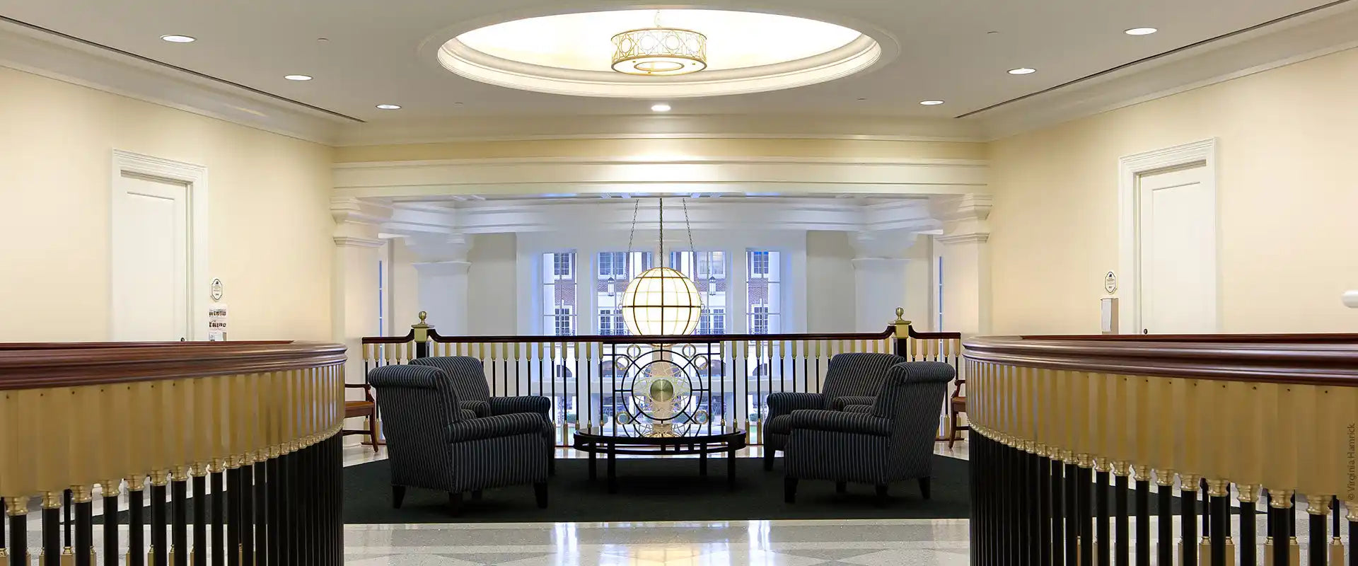 Elegant interior waiting area with armchairs and a coffee table.