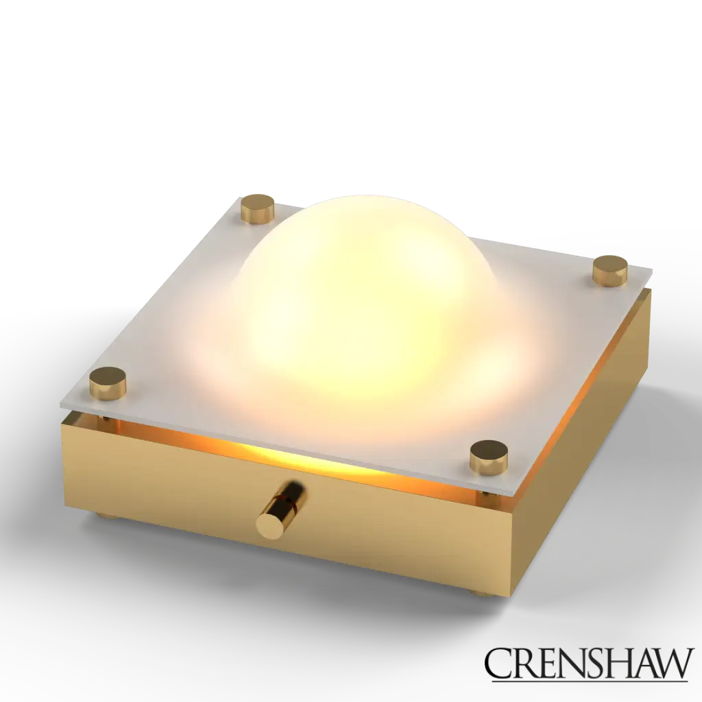 Gold-framed light fixture with a glowing white sphere on a white background