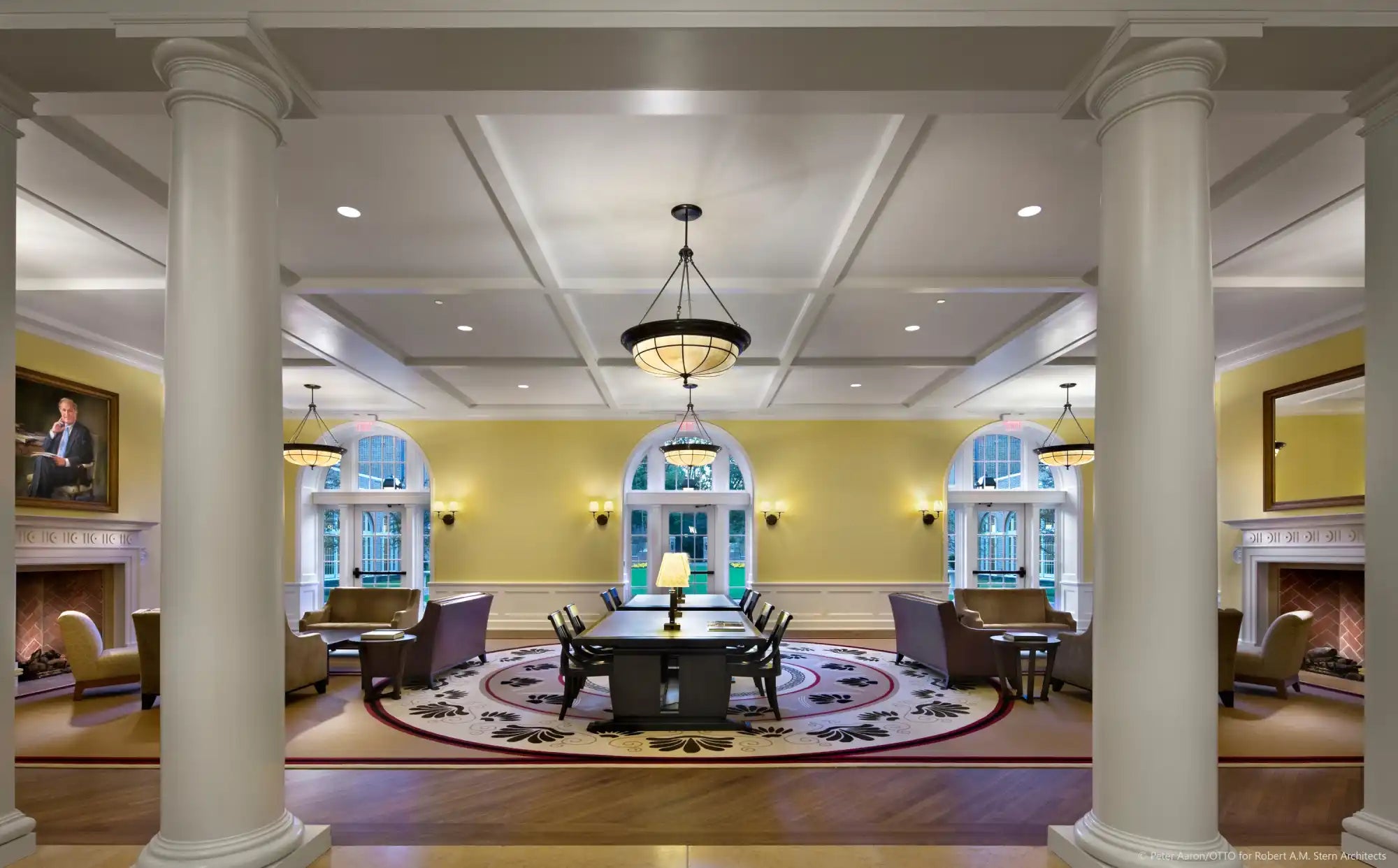 Elegant and spacious common room with multiple seating areas and a large dining table.