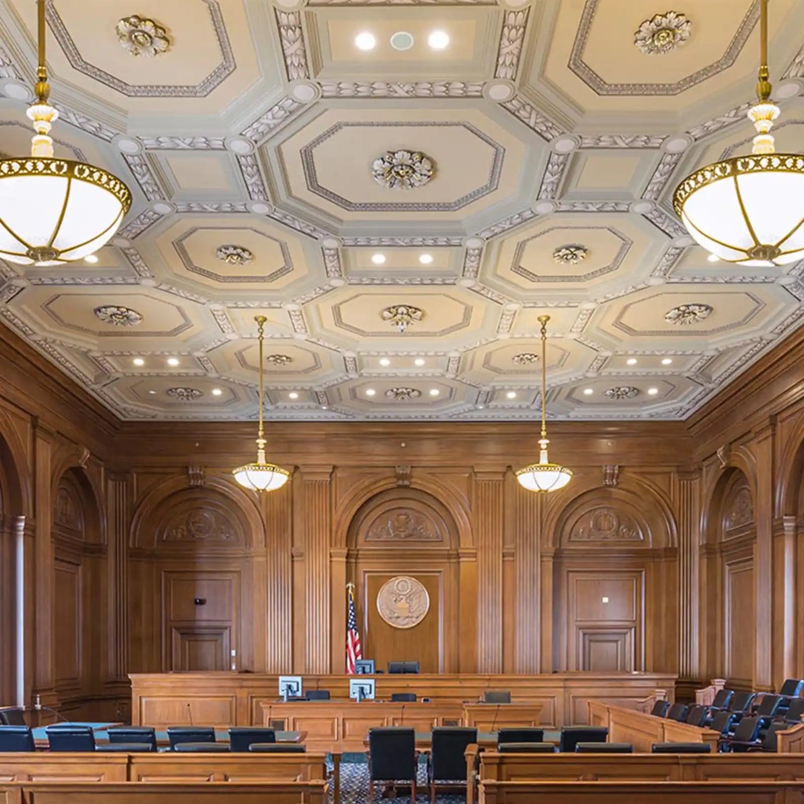 An elaborately decorated courtroom with paneled walls and a coffered ceiling.