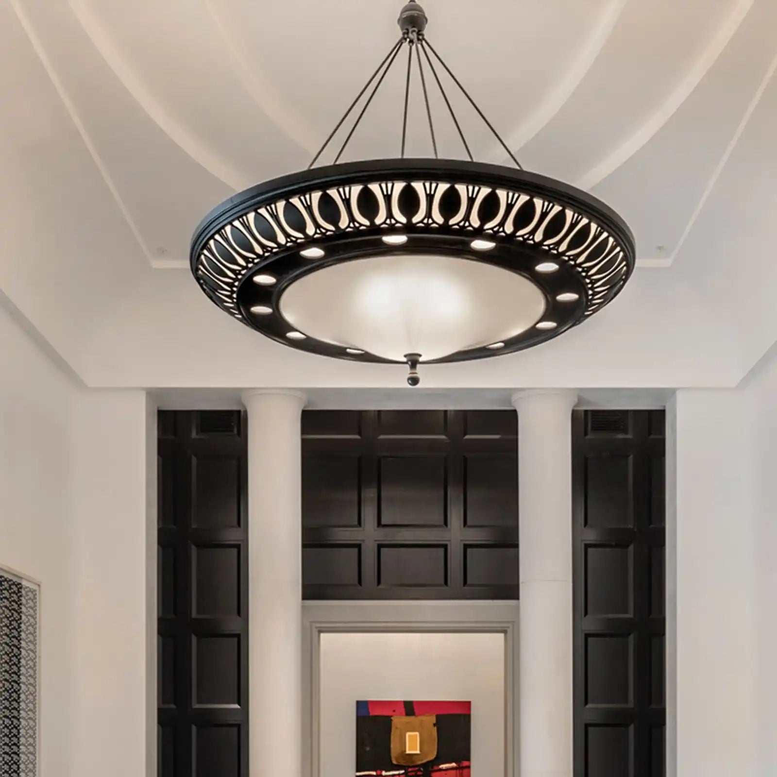 An ornate black and white chandelier with decorative cutouts.